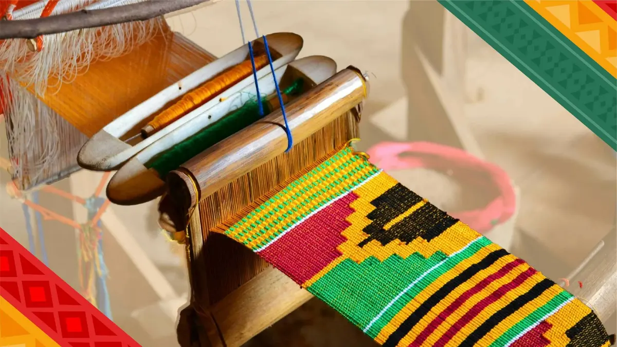 A colorful woven textile on a loom, featuring traditional patterns in red, yellow, and green.